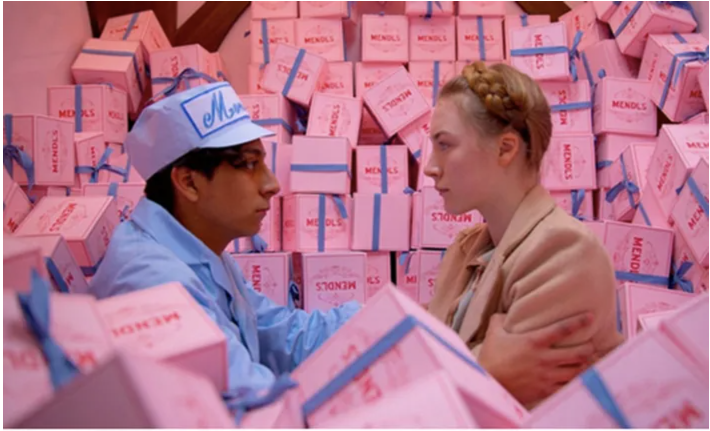 Film still with pink Mendl’s pastry boxes from The Grand Budapest Hotel